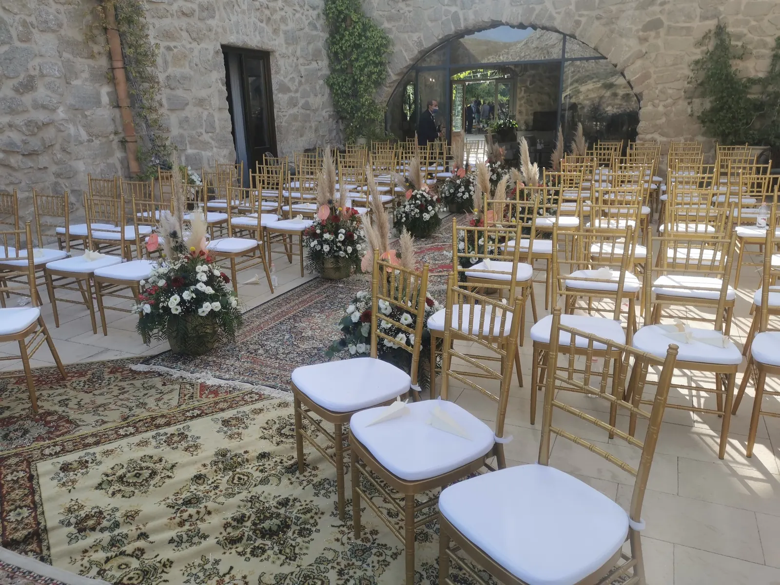Chiavari chairs and floral arrangements ready for the ceremony at the Agrigento wedding venue