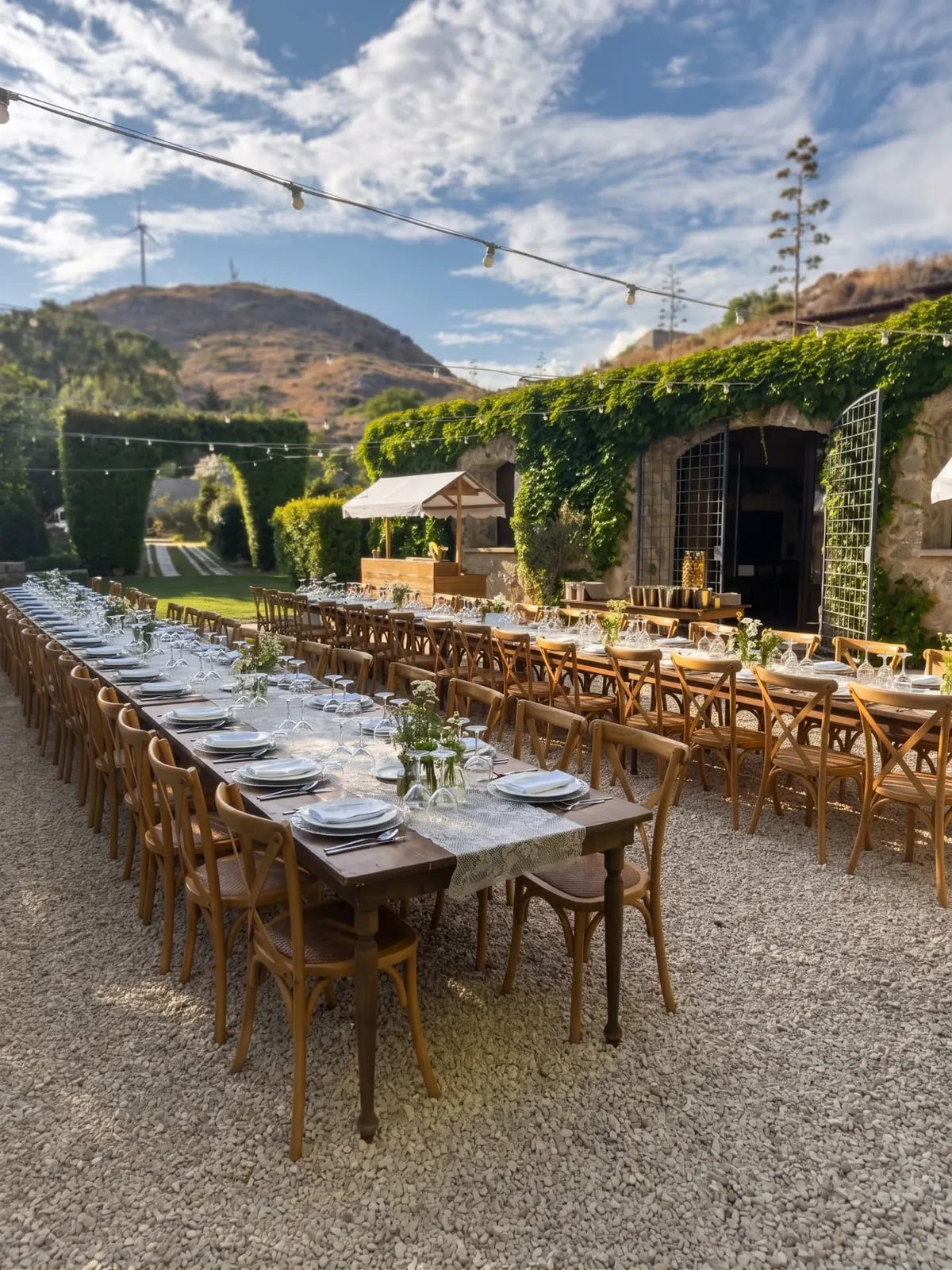 Tables set in the courtyard of the Agrigento wedding masseria, with hillside views